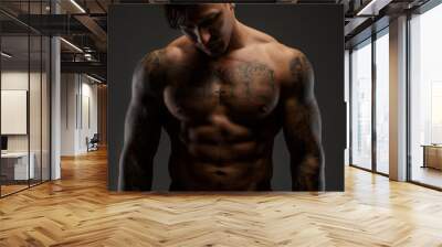 Muscular guy looking down Wall mural