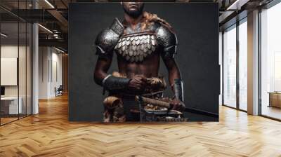 Powerful and handsome authentic soldier wearing armor with axe Wall mural