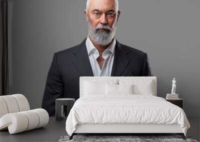 Studio shot of bearded old man dressed in elegant suit looking at camera. Wall mural