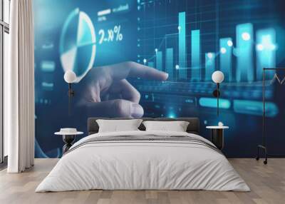 This image captures a hand interacting with futuristic financial graphs and stock market data presented digitally Wall mural