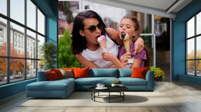 Two girls eating ice cream on a street. Wall mural