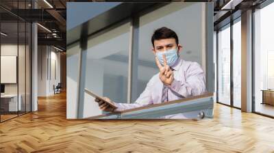 Businessman wearing hygienic face mask and giving thumbs up to protect from Virus Wall mural