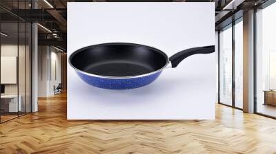 Blue pan with black handle on white background Wall mural