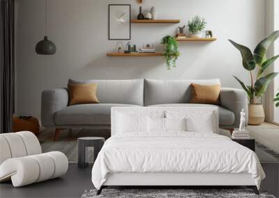 A living room with a gray couch and a plant on a shelf Wall mural