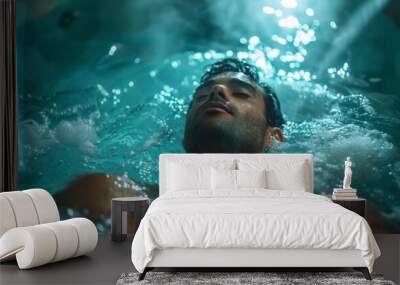 A man relaxing with an underwater massage in a spa pool with jets and soft underwater lighting. Wall mural