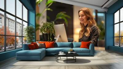 A receptionist at a business hotel reception desk, smiling as they check in corporate guests and provide conference room bookings. Wall mural