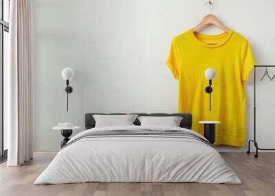 A yellow shirt is hanging on a hanger Wall mural