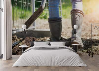 person with shovel, a man wears boots working in the garden, working gardening concept, cultivation and agriculture Wall mural