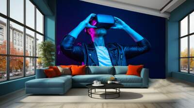 Handsome young man using a virtual reality headset Wall mural