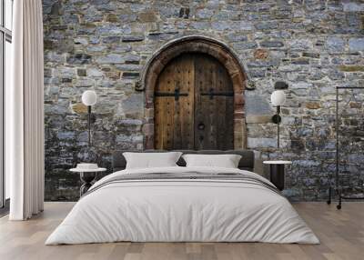 medieval castle wooden door, stone wall panorama Wall mural