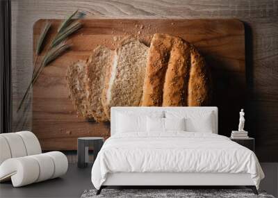 Home made and baked grain bread on a wooden table with floral decoration Wall mural