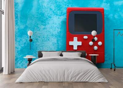 Retro video game console on a blue background, top view. Wall mural