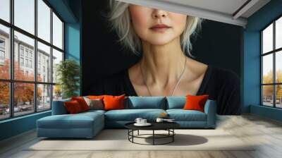 Asian woman in her fifties, with short hair and wearing a white cashmere cardigan Wall mural