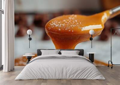 Close-Up of Caramel Dripping from Spoon Wall mural