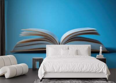 Open Book on Blue Background Wall mural