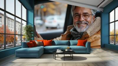 Smiling Man in a Car Holding a Smartphone Wall mural