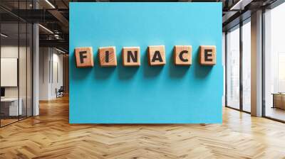 wooden cube blocks make the word finance on a blue background Wall mural