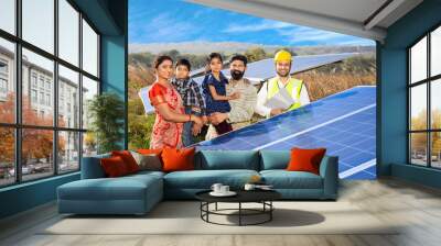 Happy rural indian family and technician with solar panels installation outdoor. renewable green energy generation concept. Eco friendly, Sustainability. Photovoltaic, Environment, Ecology.  Wall mural