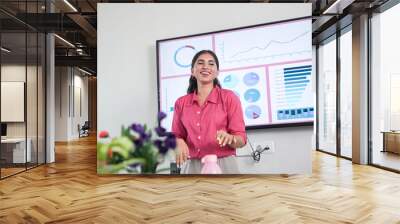 Cheerful Young indian woman at office explaining about business project in presentation or meeting. Start up, leadership and workplace concept. Wall mural