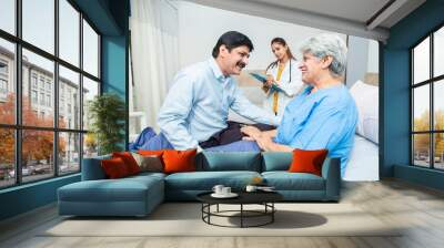 Indian man visit elderly woman patient at hospital, Son meet her old mother at clinic. Healthcare concept.  Wall mural