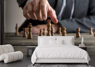 Businessman wearing business suit playing a game of chess Wall mural