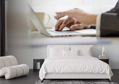 Closeup of businessman hands using laptop computer Wall mural