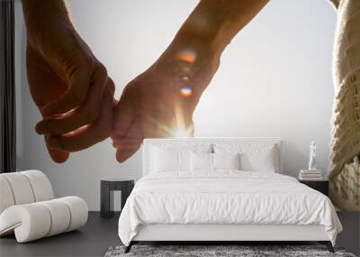 couple hands holding together with sun rays Wall mural