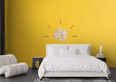 Light bulb over yellow background in vision and idea conceptual image Wall mural