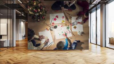 Top view of a family with two kids and a baby making Christmas decorations Wall mural