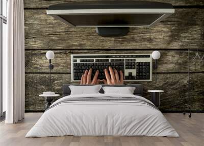 Top view of male hands typing on personal computer keyboard Wall mural