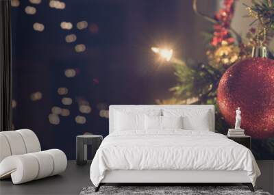 Wide view image of shiny red holiday bauble hanging on Christmas tree Wall mural