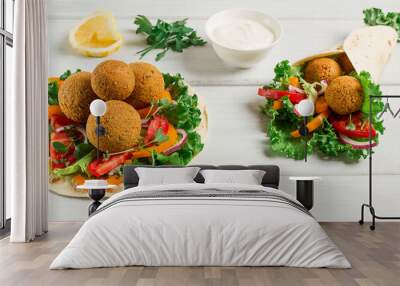 Tortillas, wrapped falafel balls, with fresh vegetables, vegetarian healthy food, on a wooden white background, no people, selective focus. Wall mural