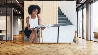 Cheerful busy woman reading journal Wall mural