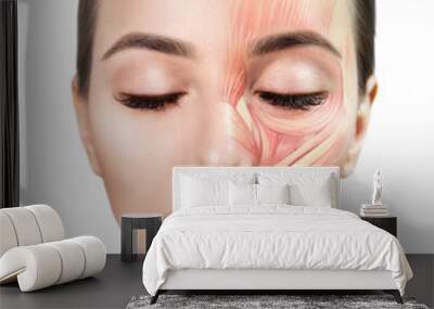 Young woman with half of face with muscles structure under skin. Over white background. Wall mural