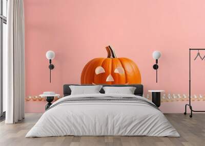 A creative layout featuring a pumpkin adorned with white pearls against a pastel pink background, embodying a minimal and aesthetic Halloween concept. Wall mural