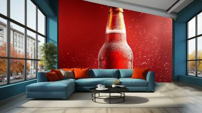 A cold bottle of beer with condensation on a red background. Wall mural