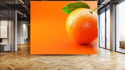 A fresh orange with leaves on a vibrant orange background. Wall mural