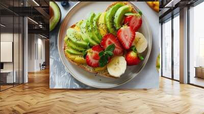 A fruit toast with avocado, strawberries, banana, and kiwi. Wall mural