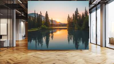 A serene landscape with a lake reflecting the setting sun and surrounding mountains. Wall mural