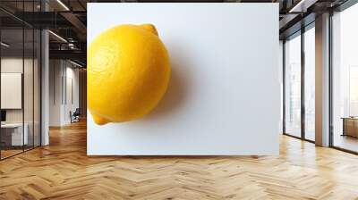 A yellow lemon on a white background. Wall mural