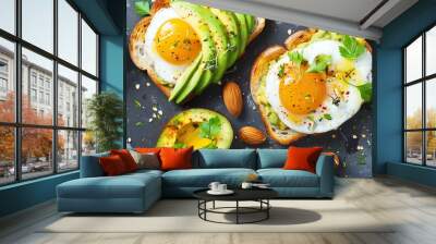 Overhead view of two slices of avocado toast with a fried egg on top. Wall mural