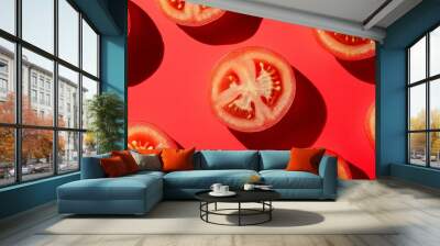 Tomato slices arranged in a repeating pattern on a red background. Wall mural