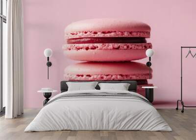 Two pink macarons with red filling, on a pink background. Wall mural