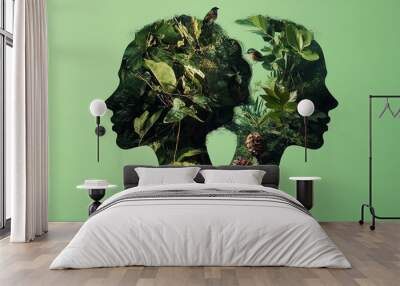 Two silhouettes of a woman's head facing each other with nature and birds overlaid on the outline. Wall mural