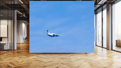 Airplane in blue sky. Air cargo transportation. Plane is flying Wall mural