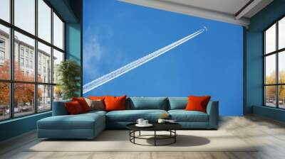 an airplane trail across the sky Wall mural