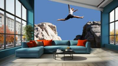 boy jumping over the mountains Wall mural