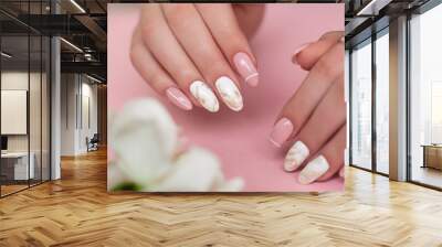 
Beautiful female hands with luxury manicure nails, pink and white gel polish Wall mural