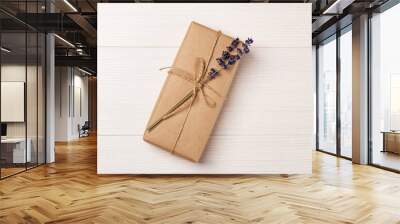 Craft gift box with lavender bouquet on a white wooden table. Eco-friendly concept. Rustic style. Romantic concept for presents. Wall mural