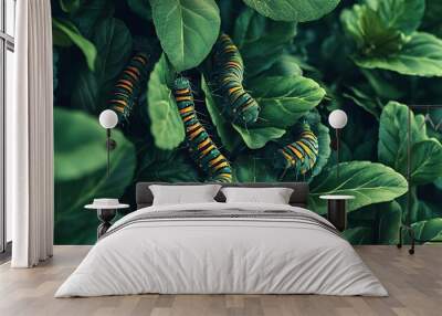 Leafy garden alive with caterpillars munching on green leaves and plants Wall mural